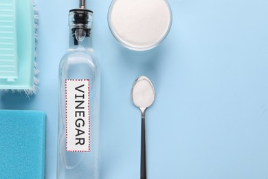 Photo of Eco friendly natural cleaners. Flat lay composition with bottle of vinegar on light blue background, space for text