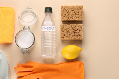 Photo of Eco friendly natural cleaners. Flat lay composition with bottle of vinegar on beige background, space for text