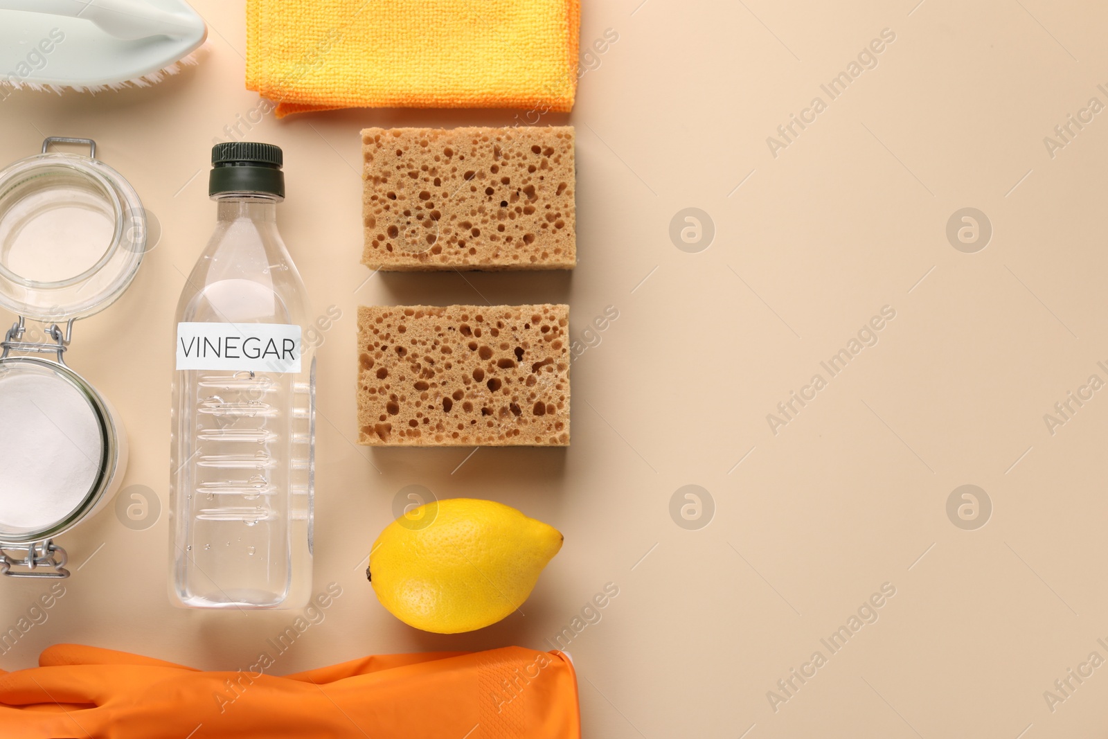 Photo of Eco friendly natural cleaners. Flat lay composition with bottle of vinegar on beige background, space for text