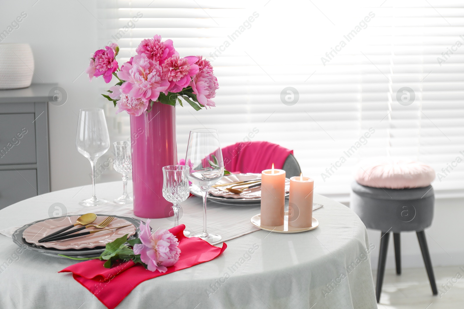 Photo of Beautiful table setting with pink peonies and burning candles