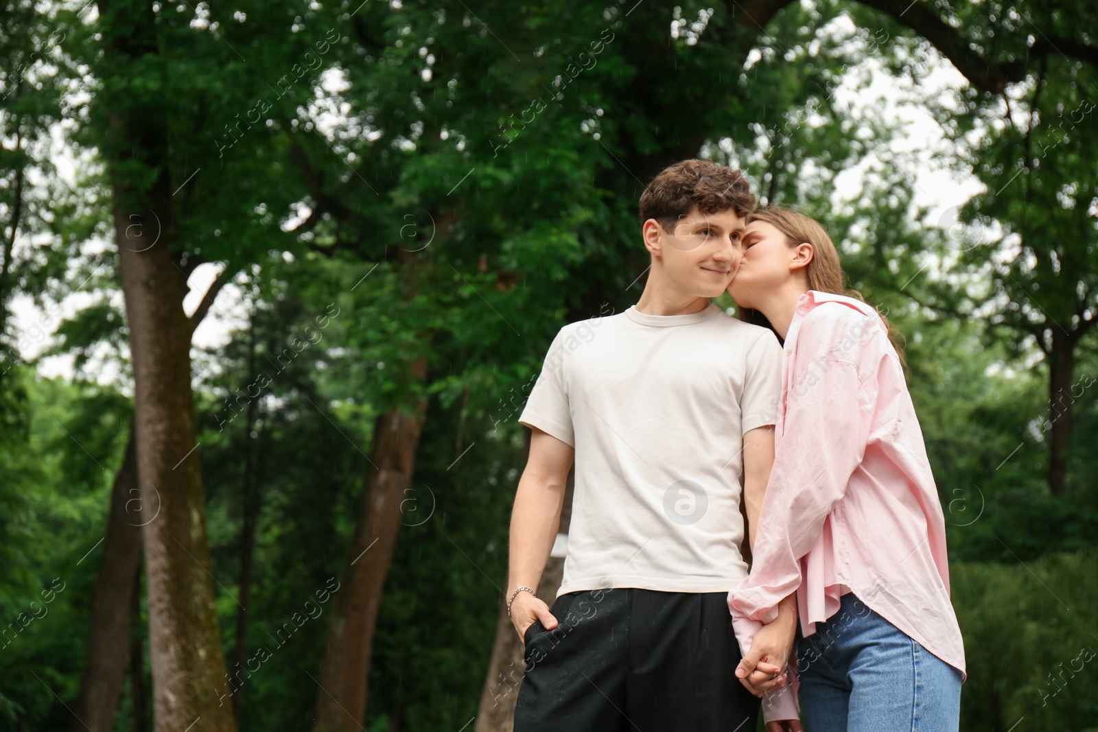 Photo of International dating. Lovely young couple spending time together in park, space for text