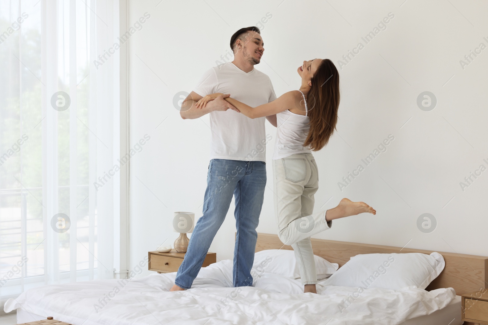 Photo of Lovely couple spending time together on bed at home