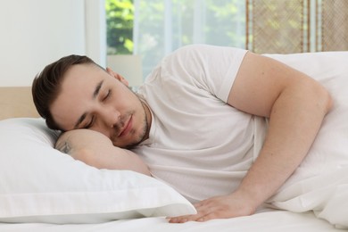 Photo of Bedtime. Handsome man sleeping in bed indoors