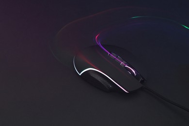 Computer mouse on dark background, space for text