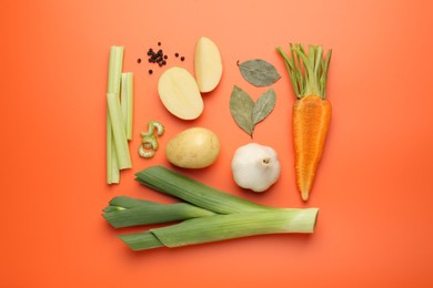 Fresh ripe carrot, vegetables and spices on orange background, flat lay