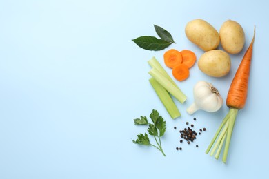 Photo of Fresh ripe carrots, vegetables and spices on light blue background, flat lay. Space for text