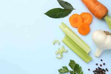 Photo of Fresh ripe carrots, vegetables and spices on light blue background, flat lay. Space for text