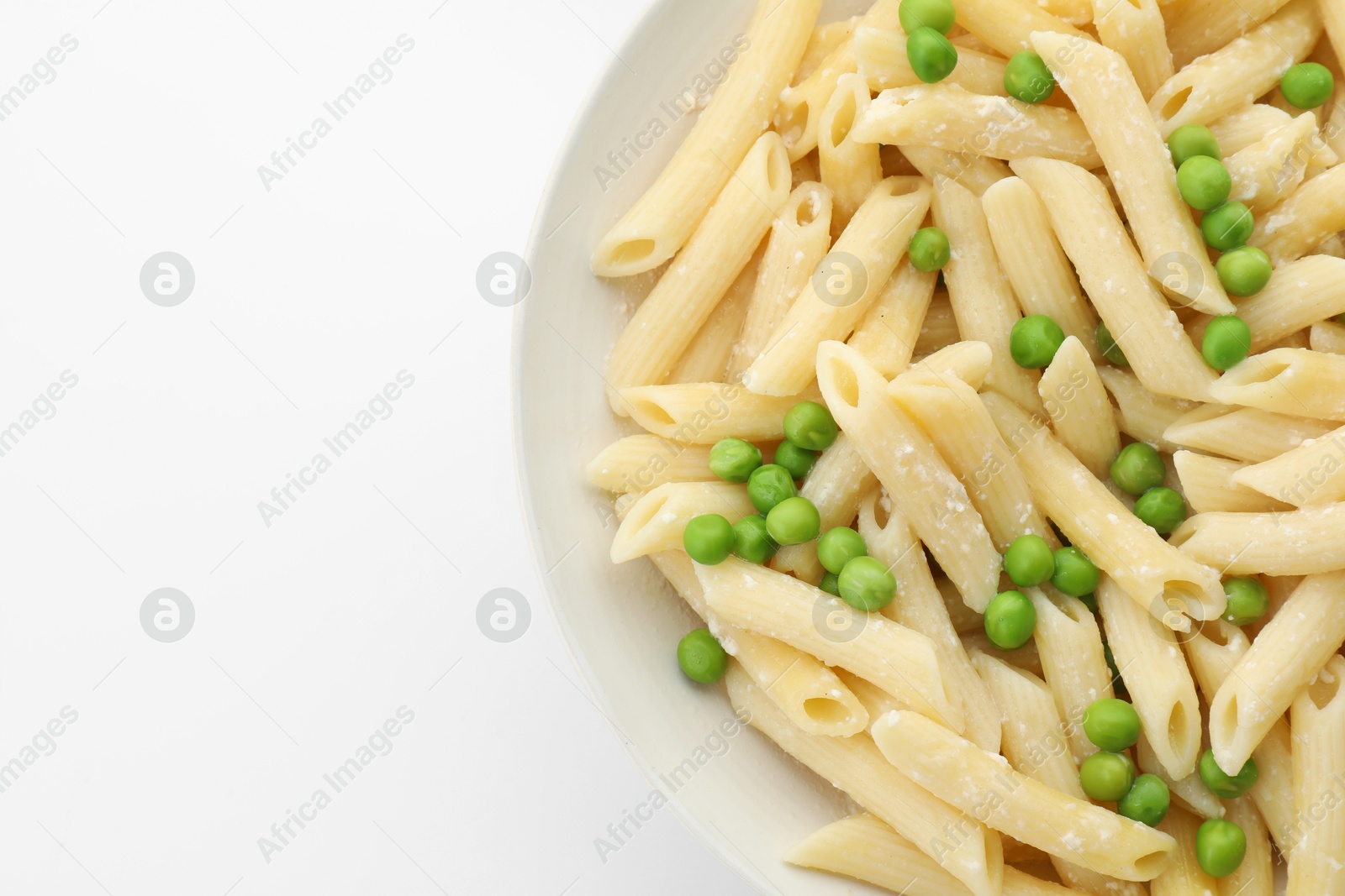 Photo of Delicious pasta with green peas and cheese in bowl on white background, top view. Space for text