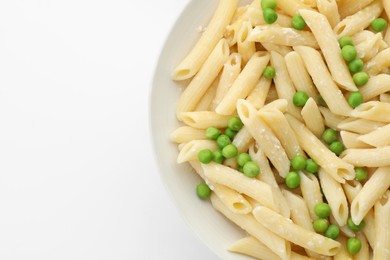 Photo of Delicious pasta with green peas and cheese in bowl on white background, top view. Space for text