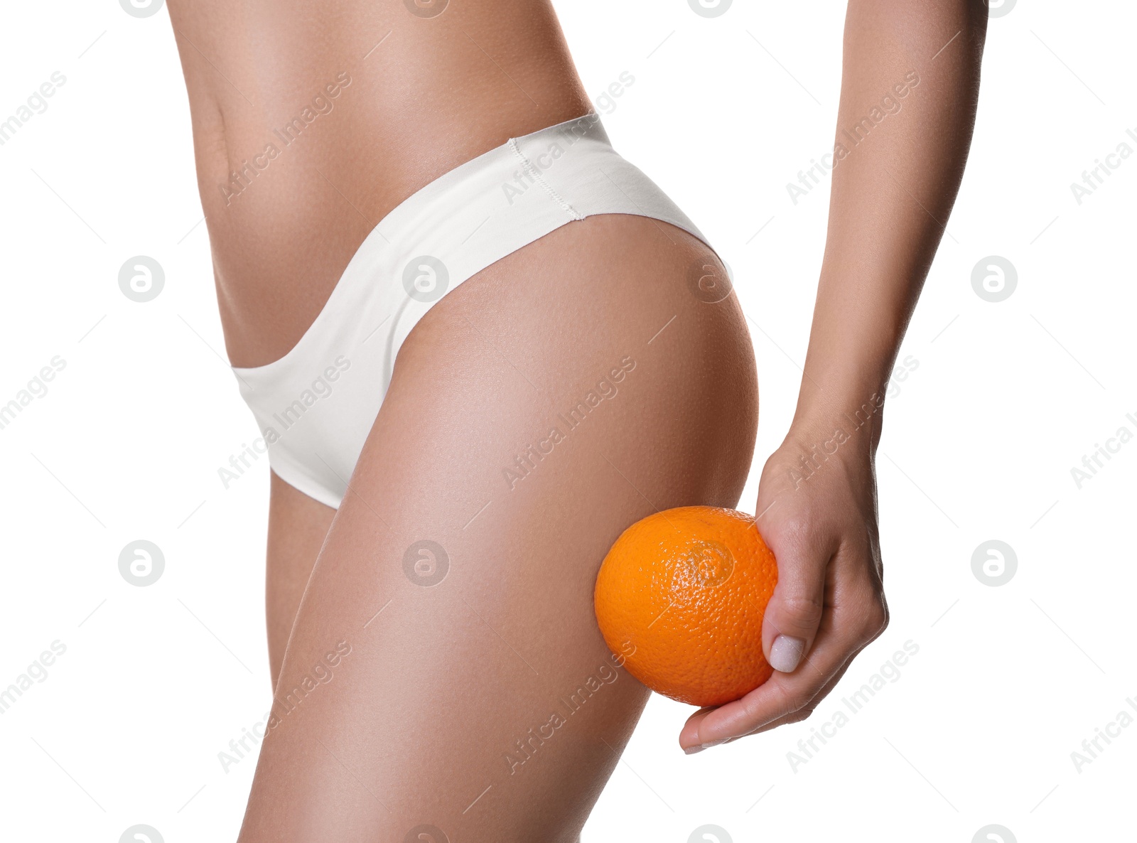 Photo of Woman in underwear with orange on white background, closeup. Cellulite problem