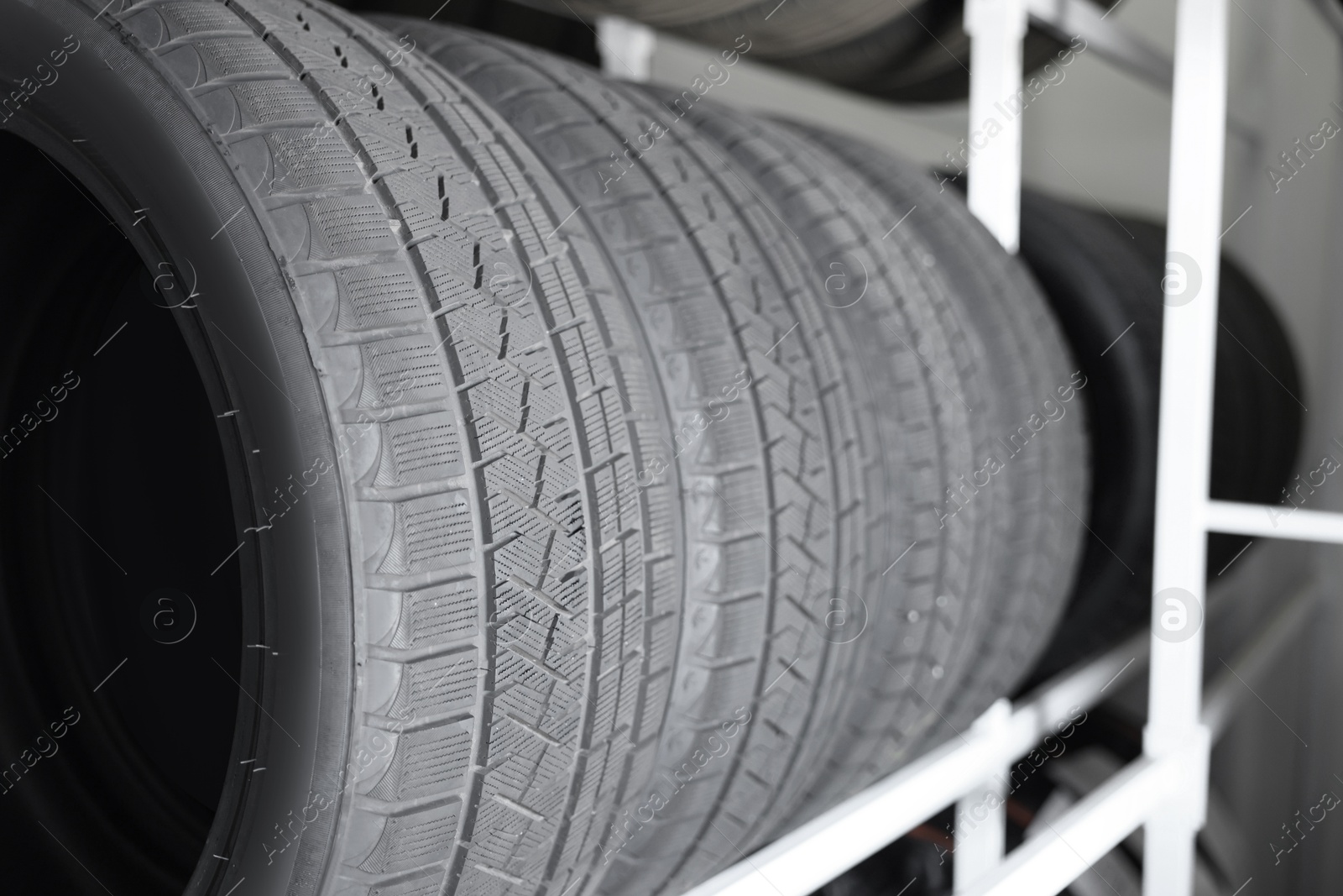 Photo of Group of car tires in auto store, closeup