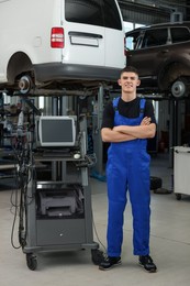 Photo of Young auto mechanic at automobile repair shop