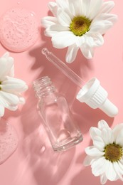 Beautiful daisy flowers, cosmetic bottle, pipette and drops of serum on pink background, flat lay