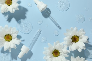 Beautiful daisy flowers, pipettes and drops of cosmetic serum on light blue background, flat lay