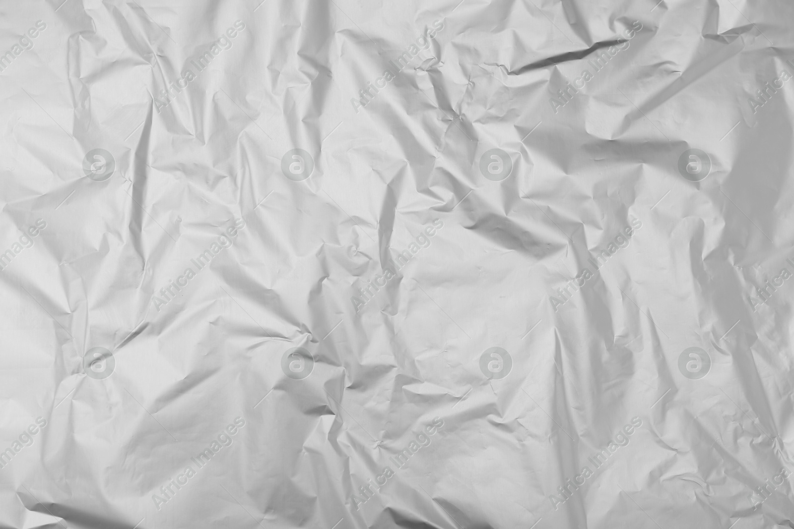 Photo of Crumpled silver foil as background, top view