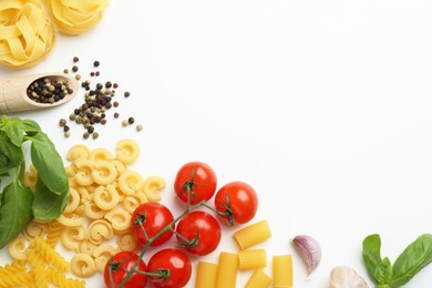 Photo of Different types of pasta, spices and products on white background, top view. Space for text