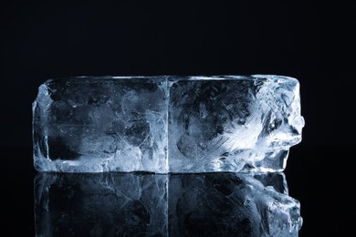Blocks of clear ice on black mirror surface
