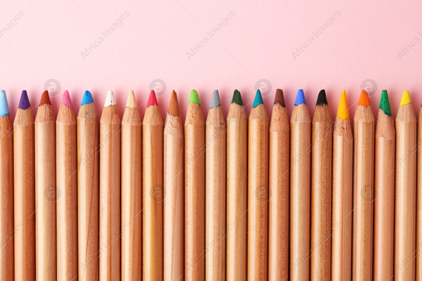 Photo of Equality concept. Different colorful pencils on pink background, top view