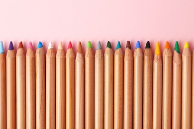Photo of Equality concept. Different colorful pencils on pink background, top view