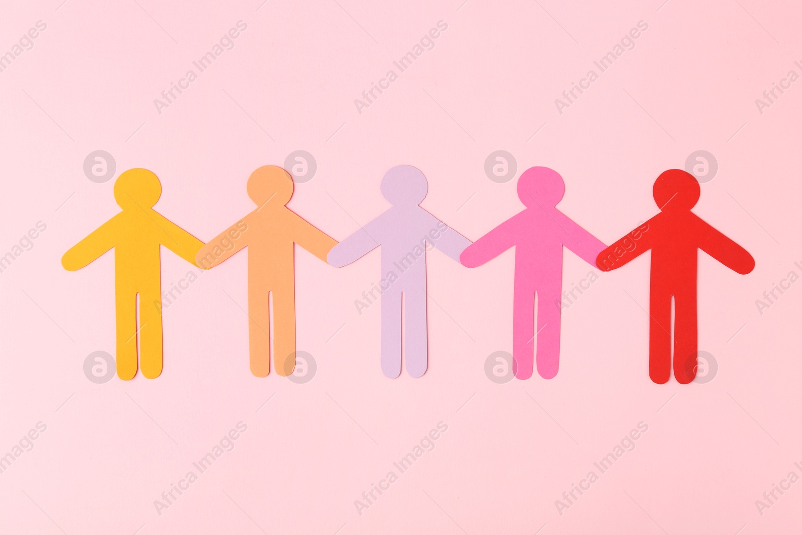 Photo of Equality concept. Paper human figures of different colors on pink background, top view