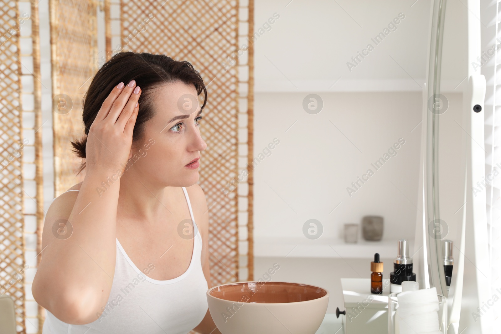 Photo of Woman with hair loss problem at home