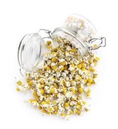 Photo of Chamomile flowers and glass jar isolated on white, top view