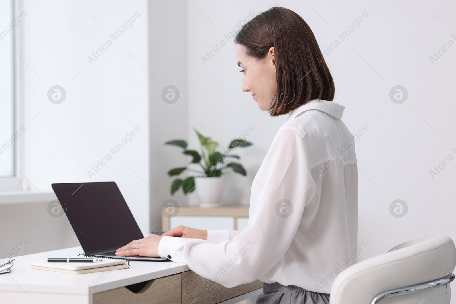 Photo of Woman with good posture working in office