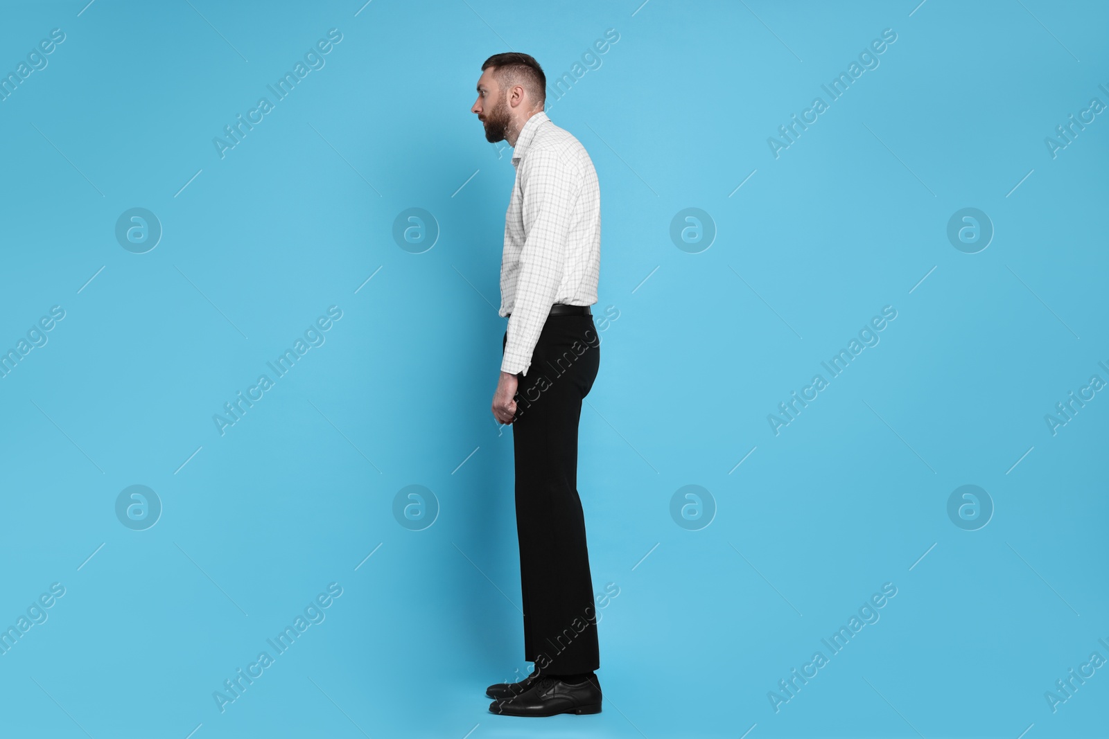 Photo of Man with poor posture on light blue background