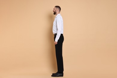 Photo of Man with good posture on pale orange background