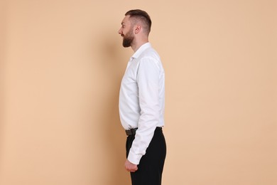 Photo of Man with good posture on pale orange background