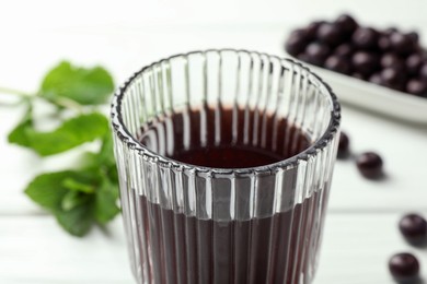 Photo of Delicious acai juice in glass on white table, closeup