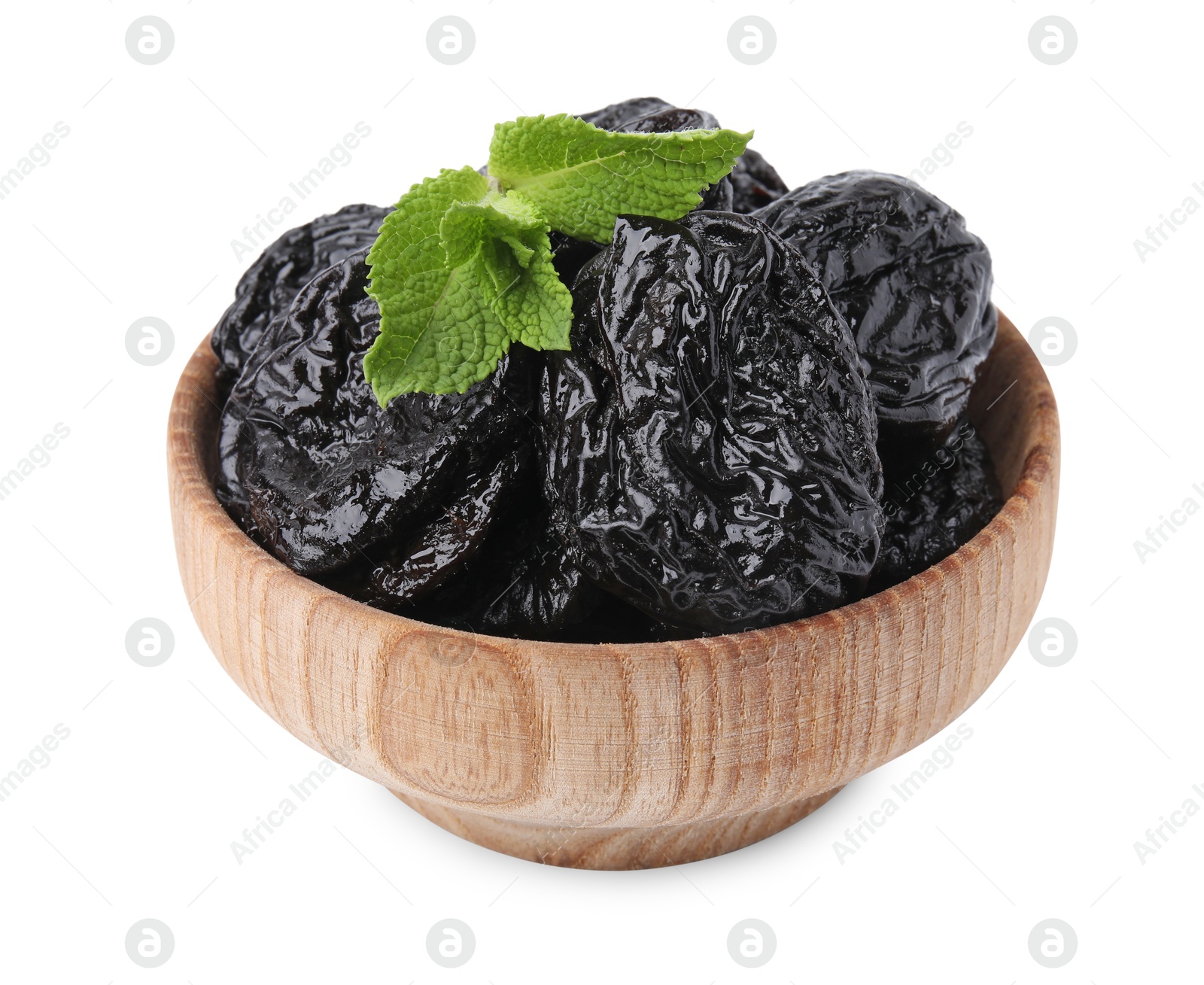 Photo of Tasty dried plums (prunes) and mint leaves in wooden bowl on white background