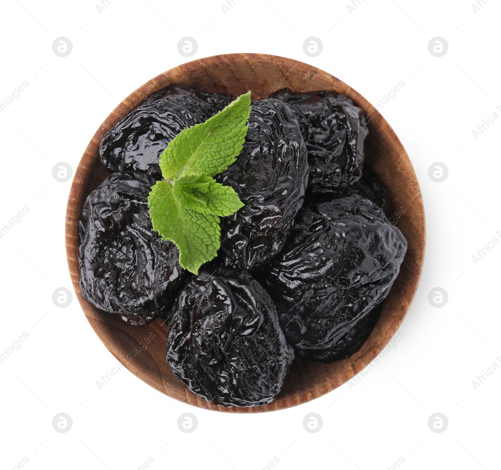 Photo of Tasty dried plums (prunes) and mint leaves in bowl on white background, top view