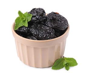 Photo of Tasty dried plums (prunes) and mint leaves in bowl on white background