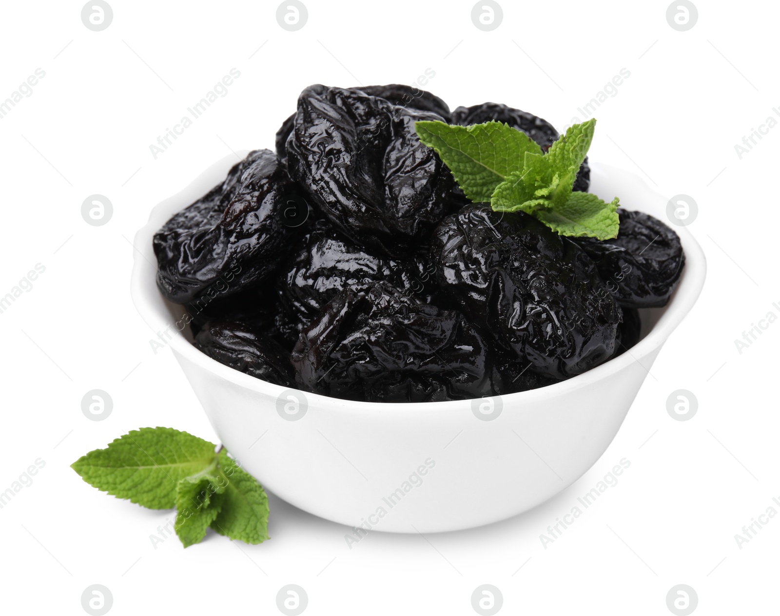 Photo of Tasty dried plums (prunes) and mint leaves in bowl on white background