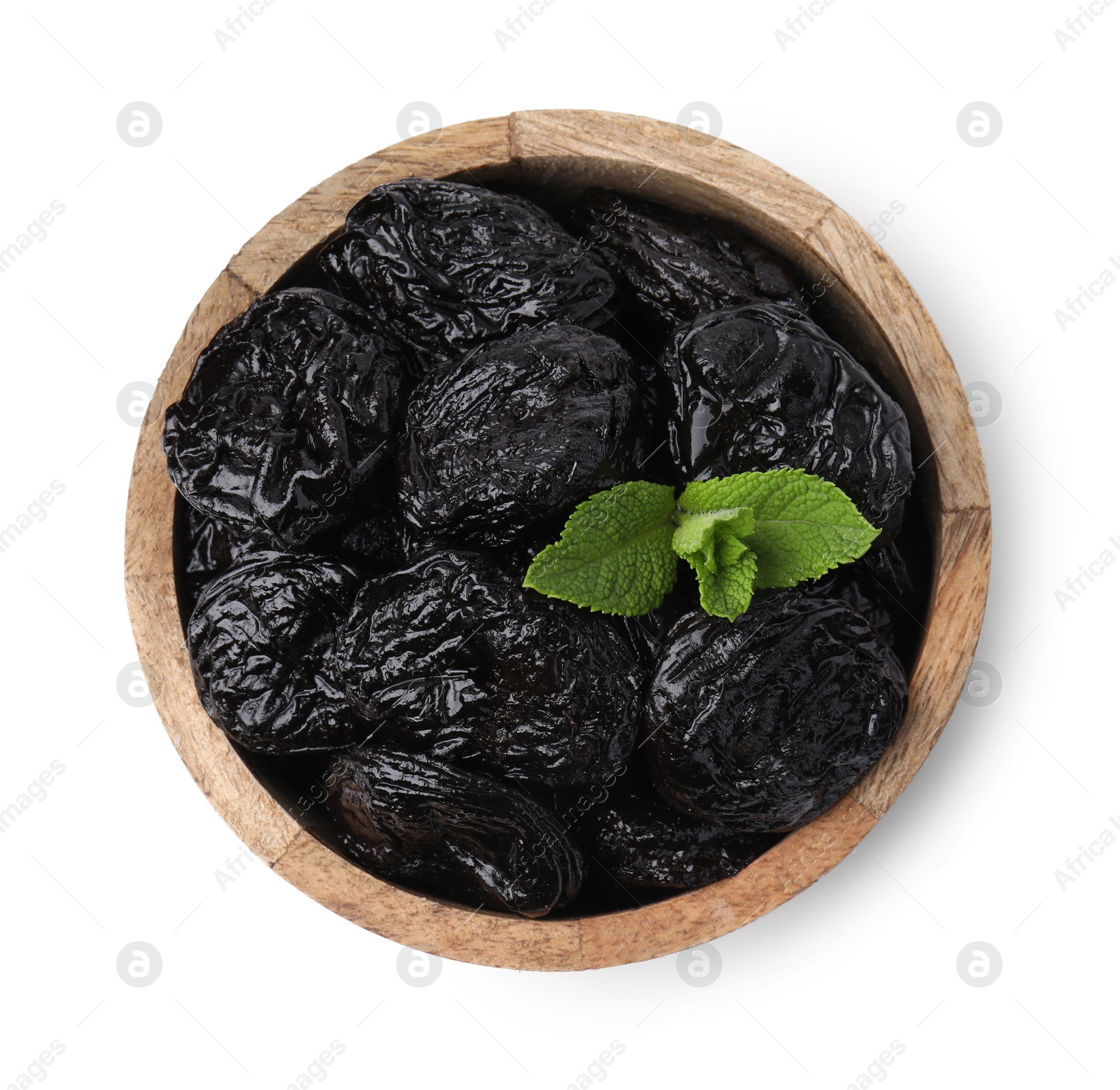 Photo of Tasty dried plums (prunes) and mint leaves in bowl on white background, top view