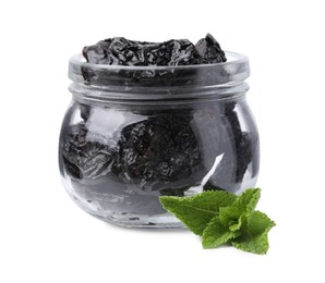 Photo of Tasty dried plums (prunes) in glass jar and mint leaves on white background