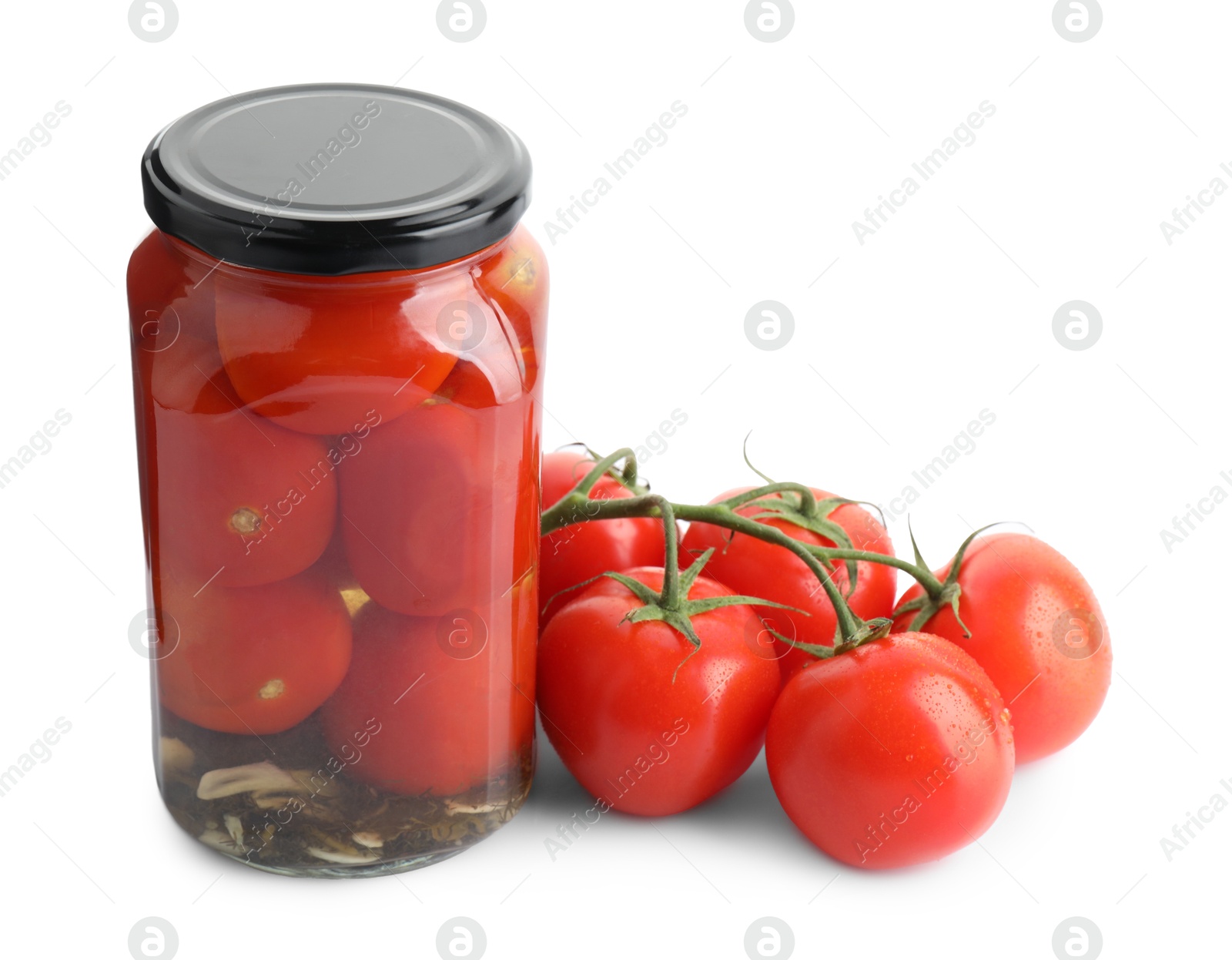 Photo of Tasty pickled tomatoes in jar and vegetable isolated on white