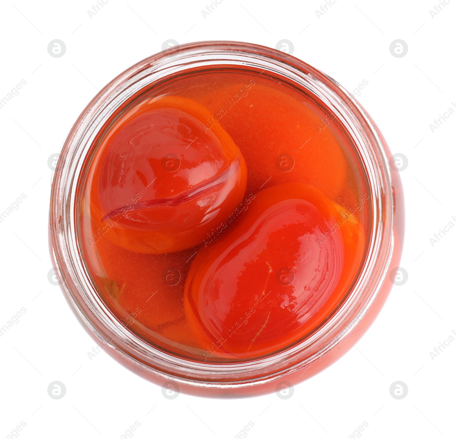 Photo of Tasty pickled tomatoes in jar isolated on white, top view