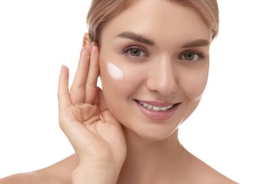 Photo of Beautiful woman with cream on her face against white background, closeup