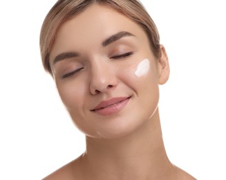 Photo of Beautiful woman with cream on her face against white background, closeup