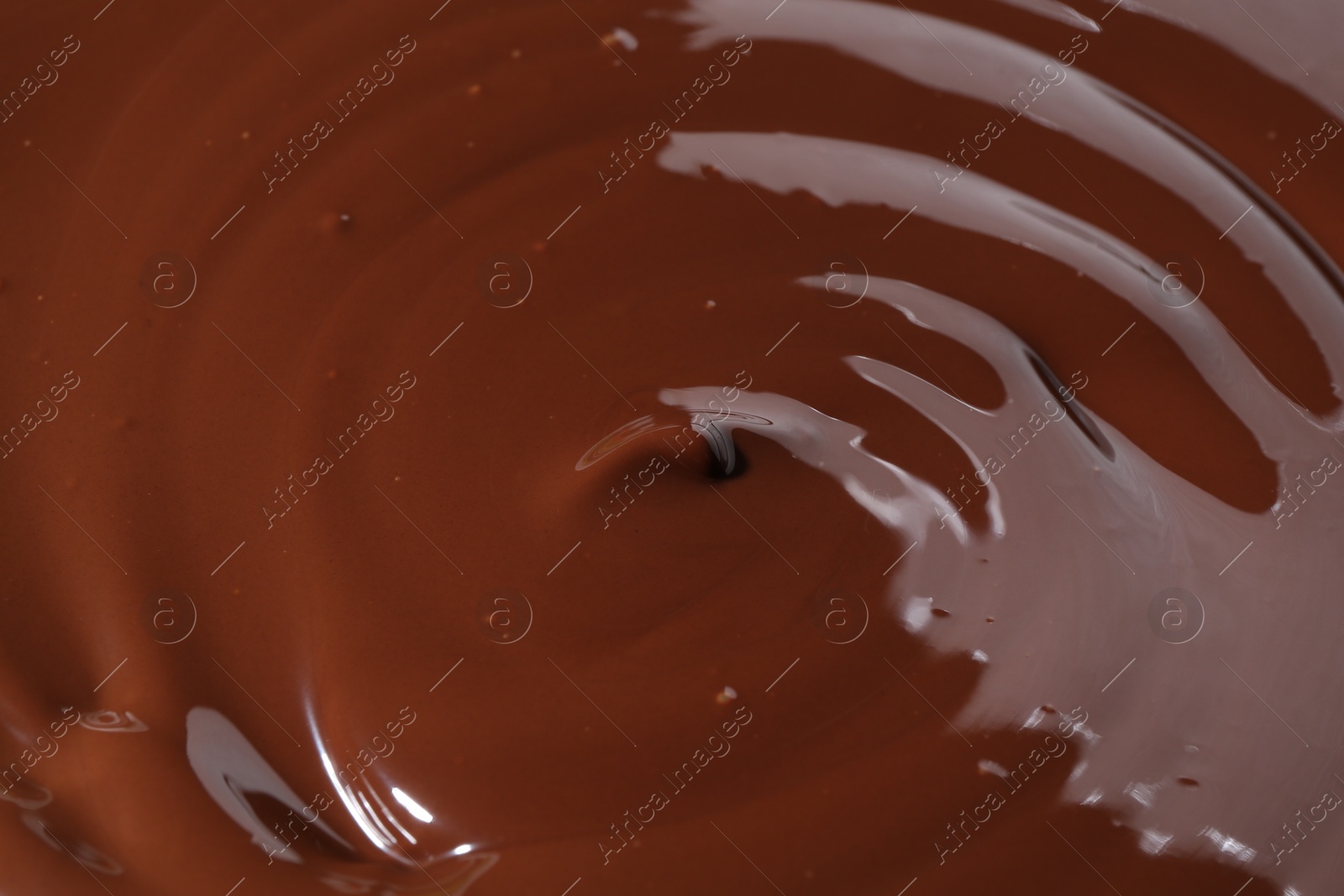 Photo of Tasty melted chocolate as background, closeup view