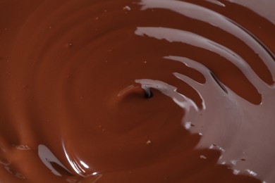 Photo of Tasty melted chocolate as background, closeup view