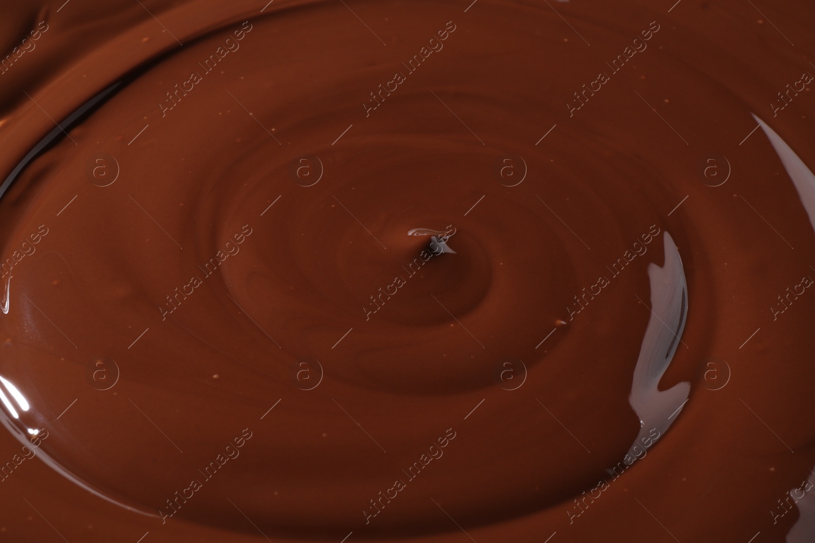 Photo of Tasty melted chocolate as background, closeup view