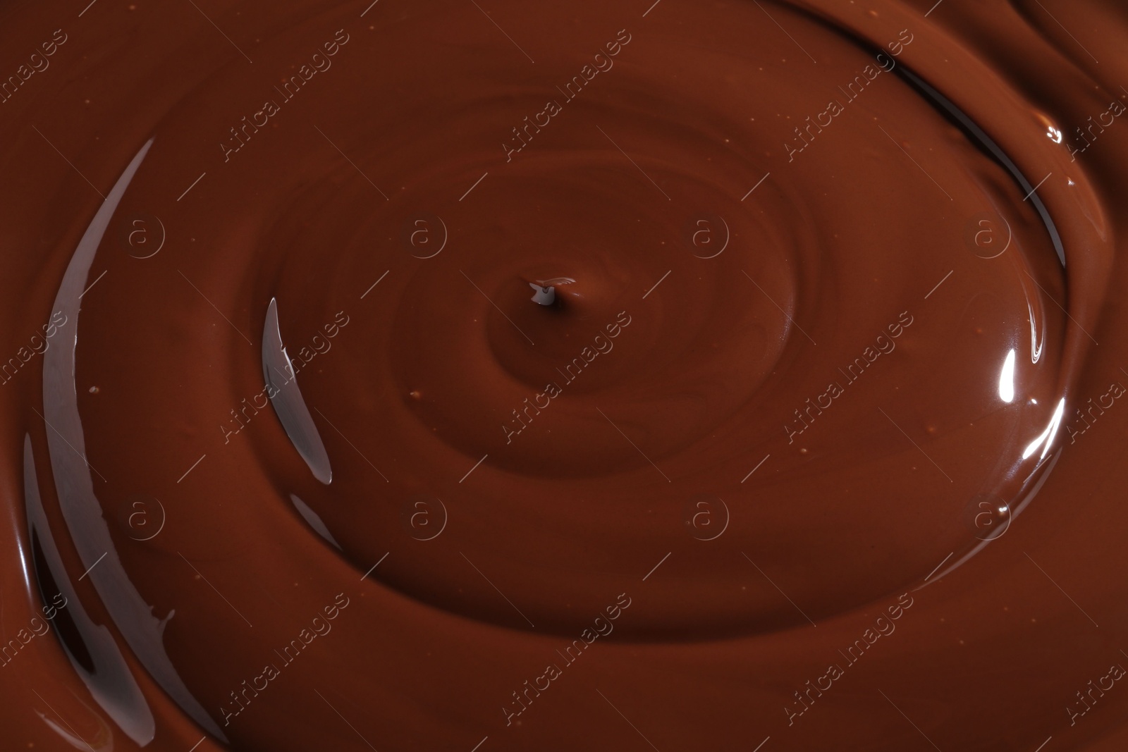 Photo of Tasty melted chocolate as background, closeup view