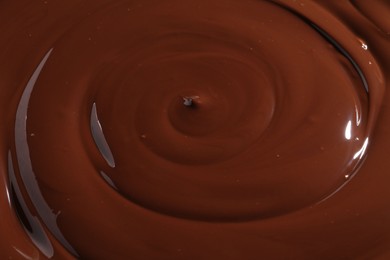 Photo of Tasty melted chocolate as background, closeup view