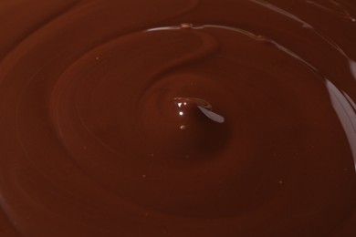 Photo of Tasty melted chocolate as background, closeup view