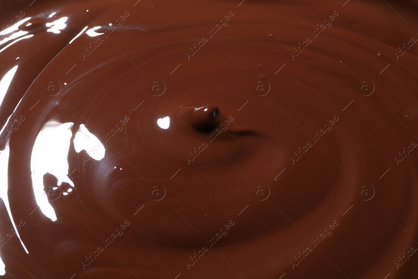 Photo of Tasty melted chocolate as background, closeup view