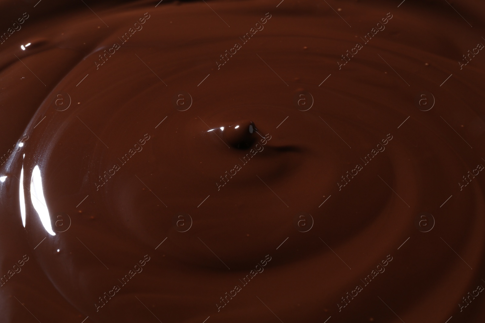 Photo of Tasty melted chocolate as background, closeup view