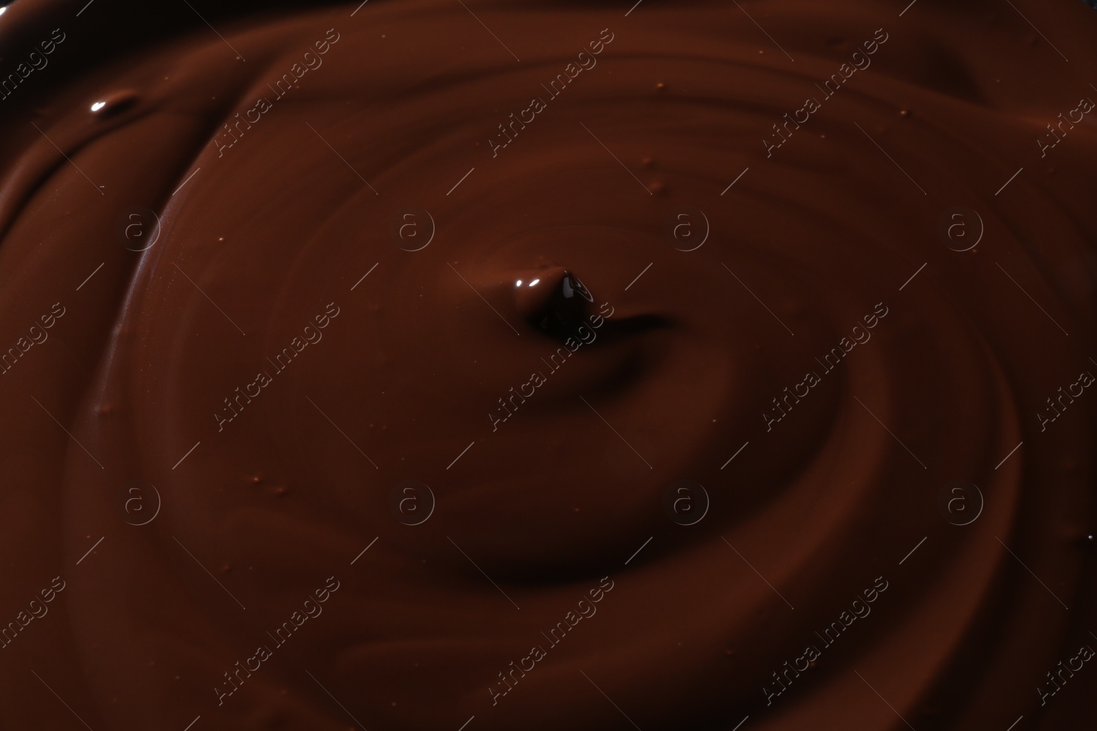 Photo of Tasty melted chocolate as background, closeup view